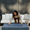 Fire pit table burning with ceramic spheres arranged around the stainless steel burner pan