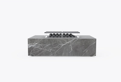 Rectangular OuterStone fire pit table in gray marbled stone with cast iron griddles fitted over the burner