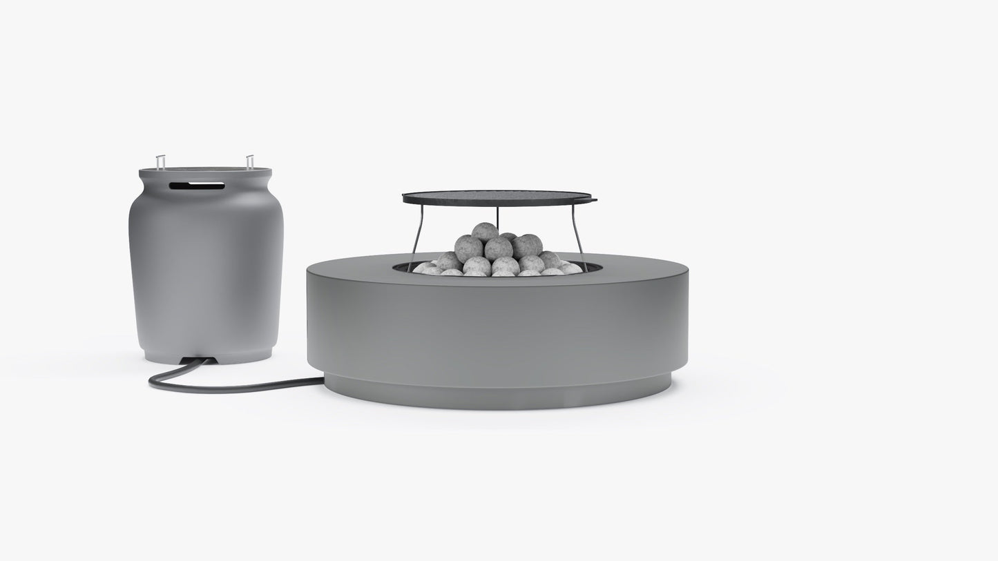 Round gray concrete fire pit table with grill grate and lava rocks, connected to a propane tank