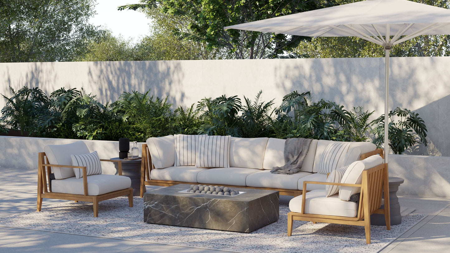 OuterStone fire pit table lit beside outdoor seating with striped cushions