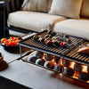Food cooking on the griddle with the splatter guard protecting the concrete tabletop