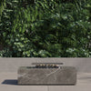OuterStone rectangular fire pit table with cooking set on a patio at dusk