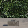 Square OuterStone fire pit table with cooking set on a patio at dusk
