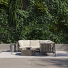 Square OuterStone fire pit lit at dusk with the propane tank cover used as a side table