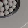 Close-up of the flame and ceramic spheres in the round burner pan