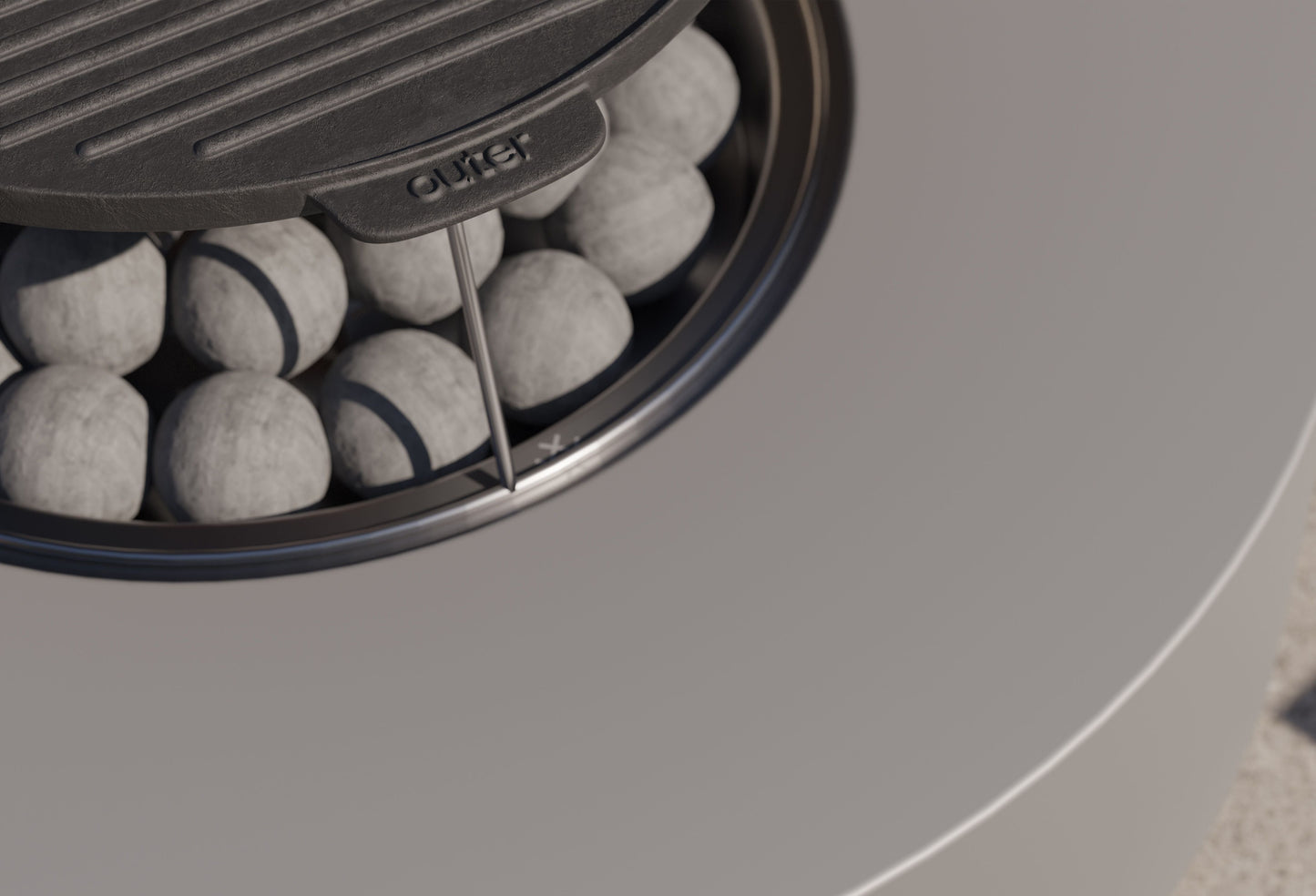 Close-up of the round cast iron griddle in place over the lit burner