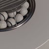 Close-up of the round cast iron griddle in position over the flame