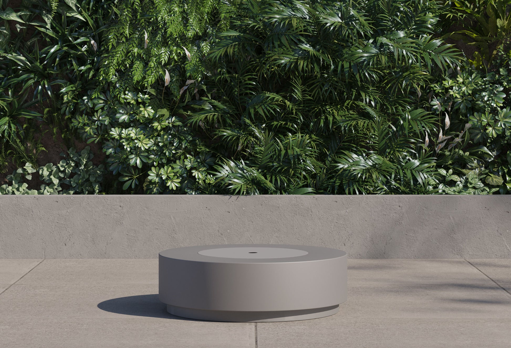 Round fire pit table with the burner cover in place, used as a low coffee table