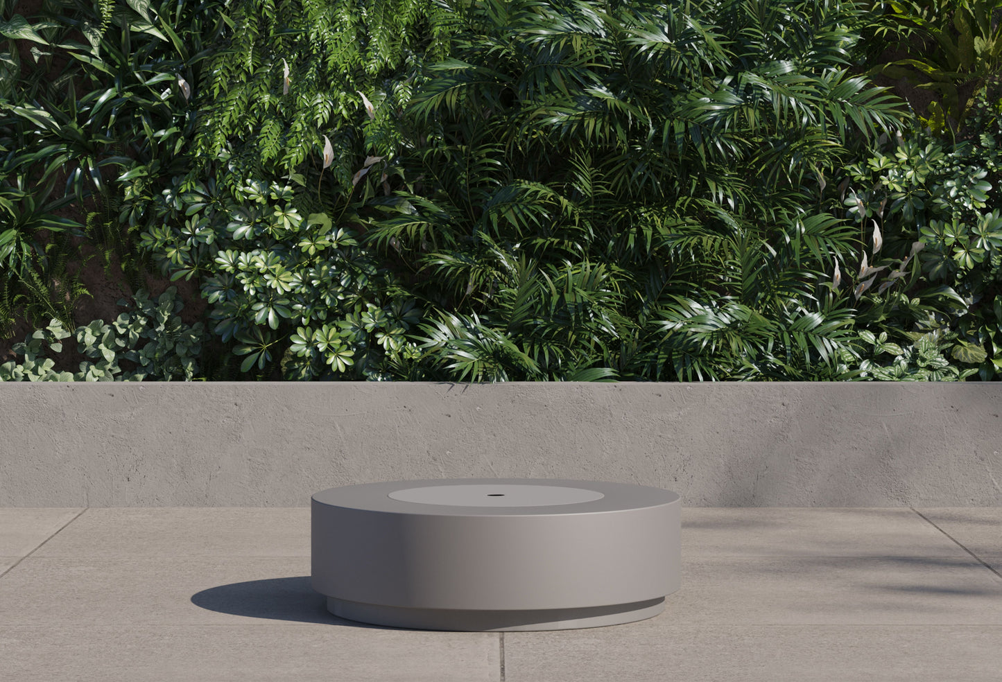 Round fire pit table with the burner cover in place, used as a low coffee table