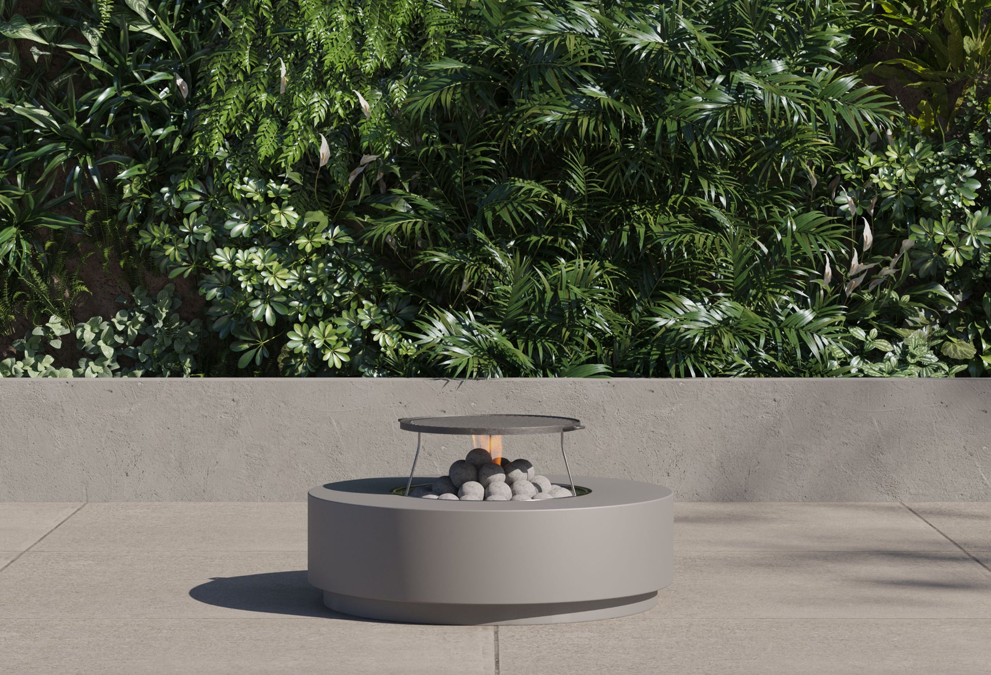 Round concrete fire pit table with the griddle fitted over the lit burner