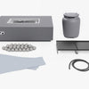 The set components laid out: propane tank cover, gas hose, griddle plates, splatter guard and ceramic spheres