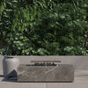 OuterStone rectangular fire pit on a patio beside its stone-topped propane tank cover