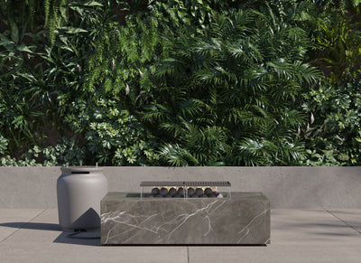 OuterStone rectangular fire pit on a patio beside its stone-topped propane tank cover